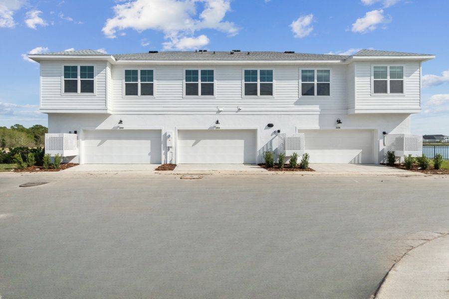 Front exterior of a new home in Emerald Landing at Waterside at Lakewood Ranch – Towns, Sarasota, FL, highlighting curb appeal (Image 25).