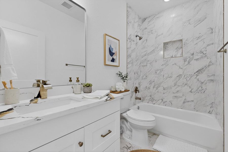 Bathroom featuring vanity and washtub / shower combination