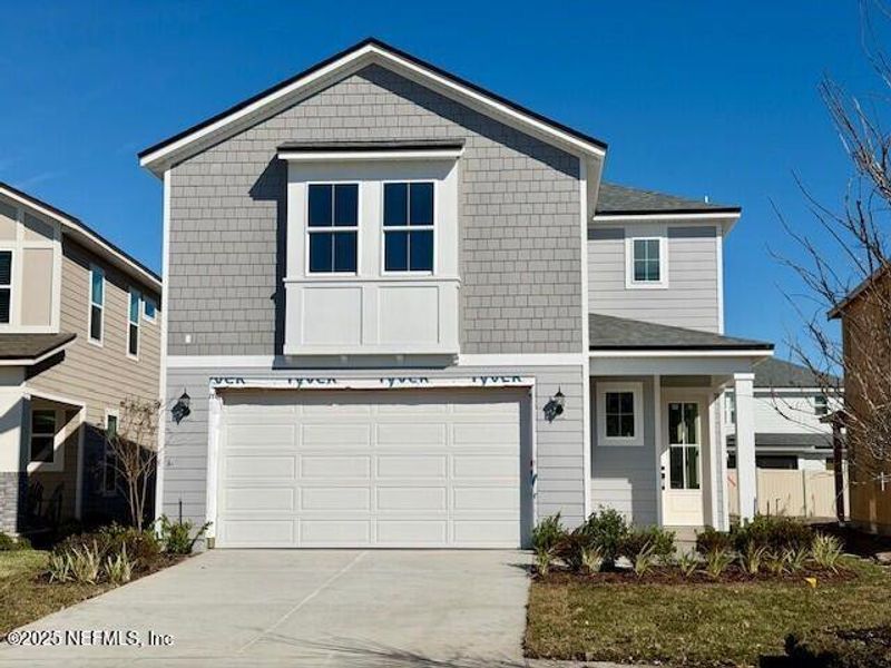 Front exterior of a new home in Crosswinds at Nocatee, Ponte Vedra, FL, highlighting curb appeal (Image 20).