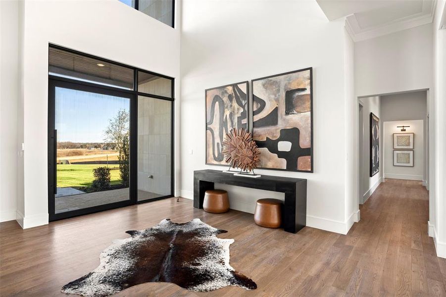 The light filled foyer boast soaring ceilings and looks through to the outdoor living.