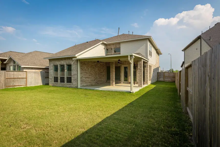 Front exterior of a new home in Cane Island 50', Katy, TX, highlighting curb appeal (Image 2). Front exterior of a new home in Cane Island 50', Katy, TX, highlighting curb appeal (Image 2).