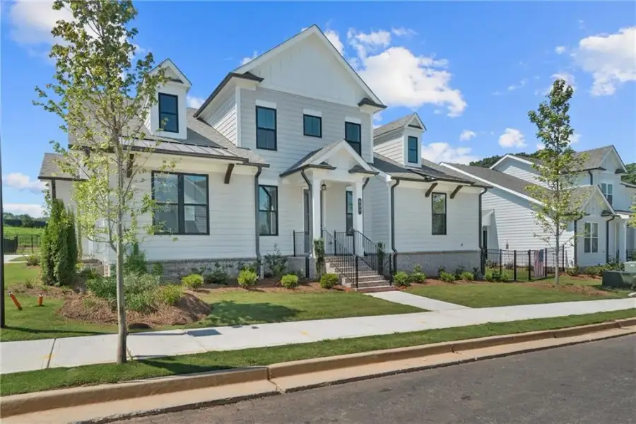Front exterior of a new home in Promenade at Sawnee Village, Cumming, GA, highlighting curb appeal (Image 21).