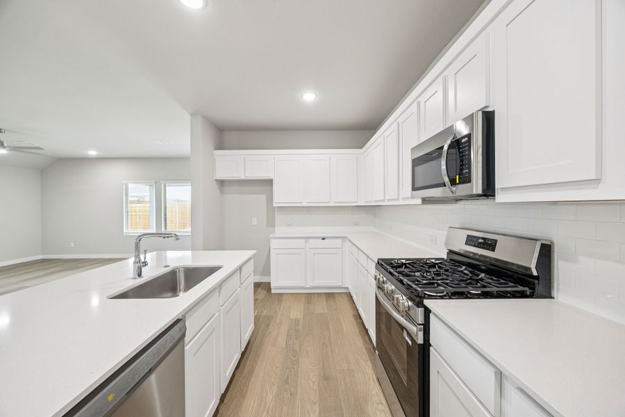 Kitchen in the Hayden home plan by Trophy Signature Homes – REPRESENTATIVE PHOTO