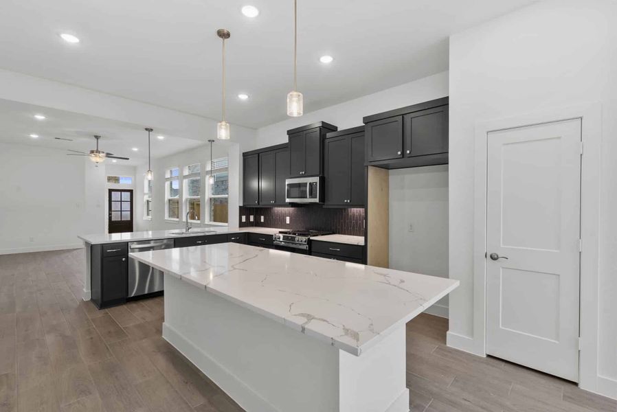 Representative furnished interior of a home built from the Carlisle by Chesmar Homes in Sunterra, Katy (Image 6).