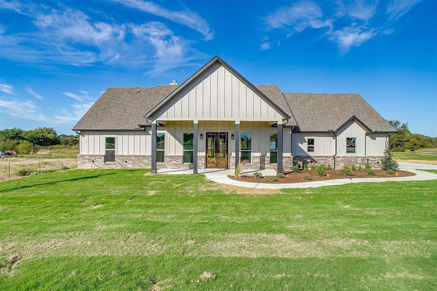 Modern inspired farmhouse with french doors and a front yard