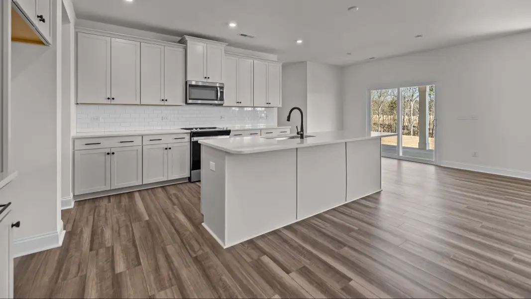 The Norris Plan by DRB Homes in Michaux Gardens - Kitchen & Living Space (Representative Photo) The Norris Plan by DRB Homes in Michaux Gardens - Kitchen & Living Space (Representative Photo)