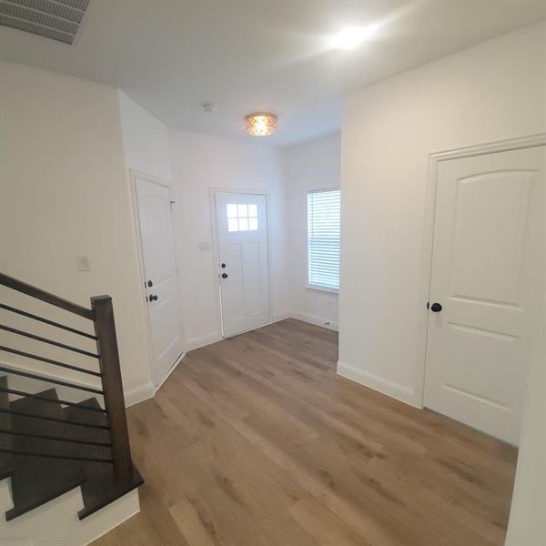 Entrance foyer with wood-type flooring