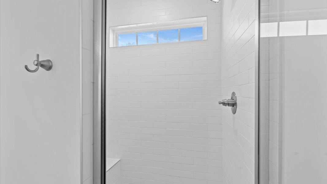 Superior en-suite primary bathroom with stylish dual vanity and walk-in shower crafted with high standards in mind