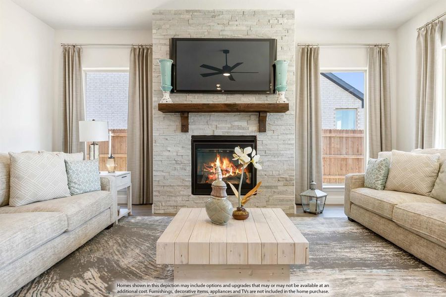Living room with stacked stone fireplace, wood mantel, wall-mounted TV, and two neutral sofas flanking a wood coffee table. Living room with stacked stone fireplace, wood mantel, wall-mounted TV, and two neutral sofas flanking a wood coffee table.