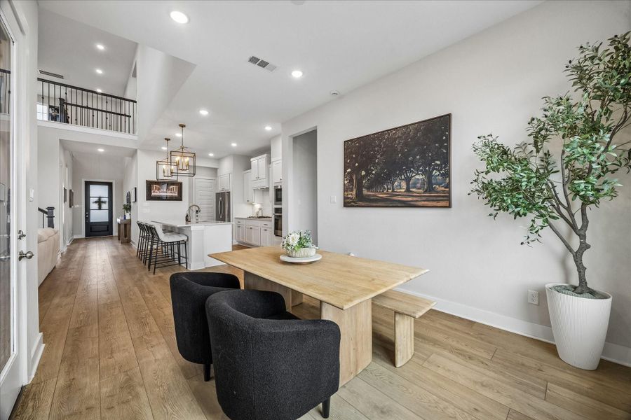 The dining space flows seamlessly into the kitchen, reinforcing the home’s open-concept design that’s perfect for both casual living and entertaining.