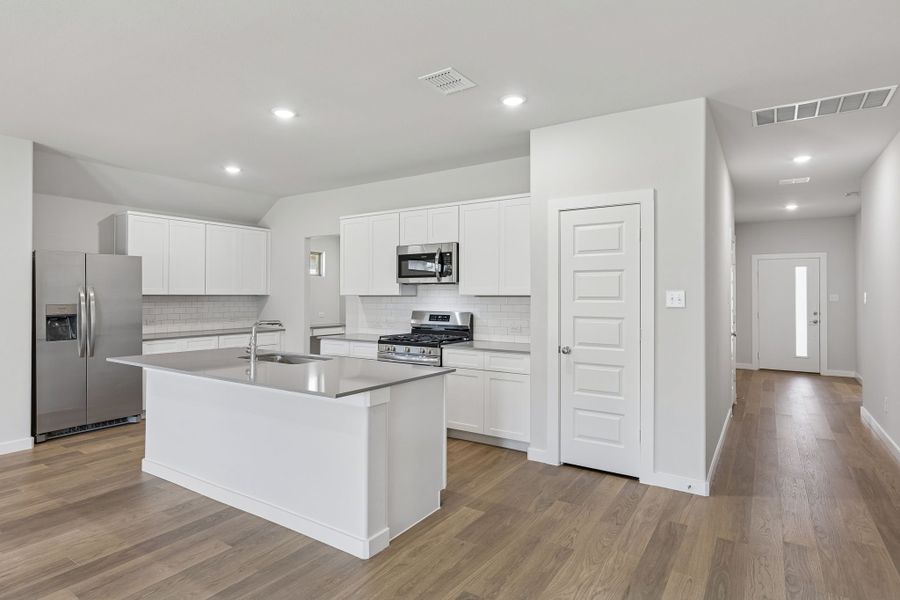 Kitchen in the Harrison home plan by Trophy Signature Homes – REPRESENTATIVE PHOTO