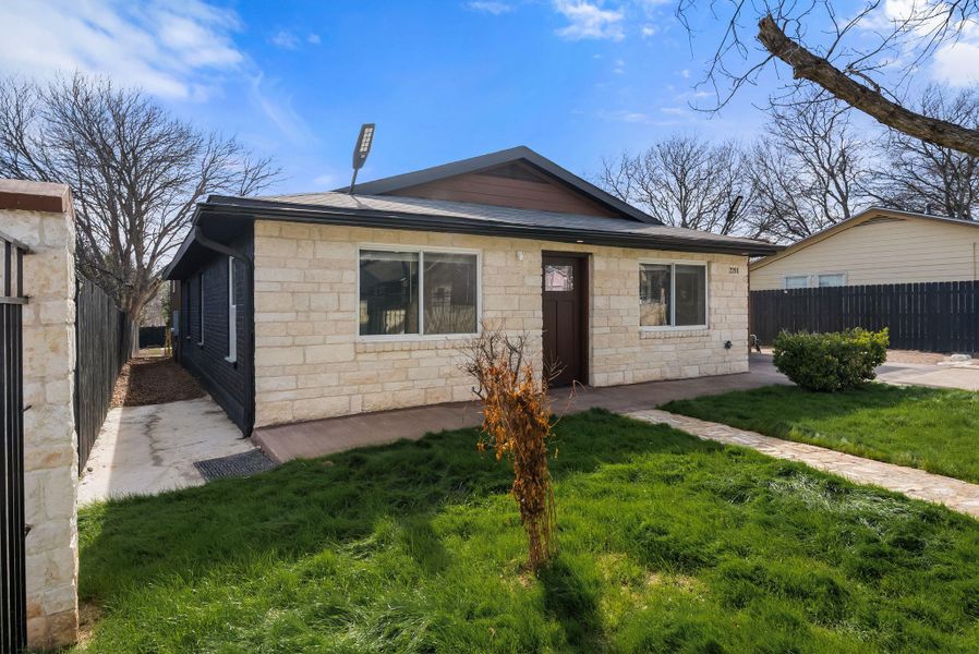 Bungalow featuring stone siding