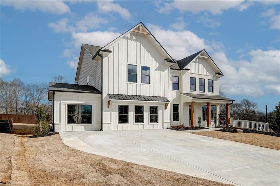 Front exterior of a new home in Summerlin, Winder, GA, highlighting curb appeal (Image 23). Front exterior of a new home in Summerlin, Winder, GA, highlighting curb appeal (Image 23).
