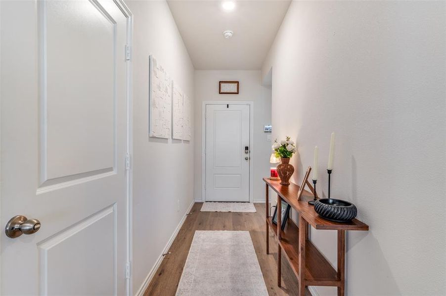 Doorway to outside featuring wood finished floors and baseboards