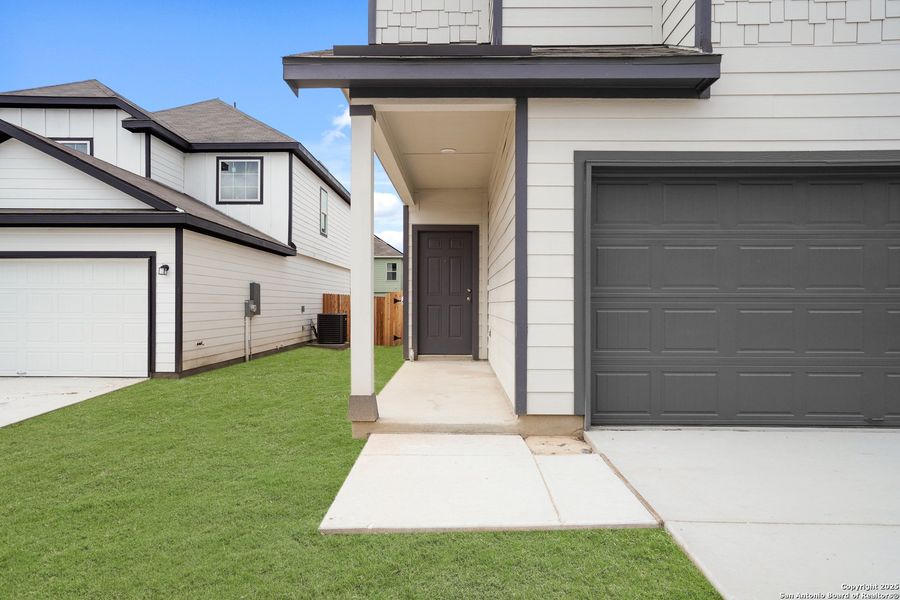 Front exterior of a new home in Melissa Ranch, San Antonio, TX, highlighting curb appeal (Image 17).