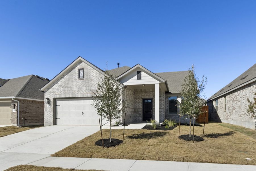 Front exterior of a new home in Crosswinds, Kyle, TX, highlighting curb appeal (Image 24).