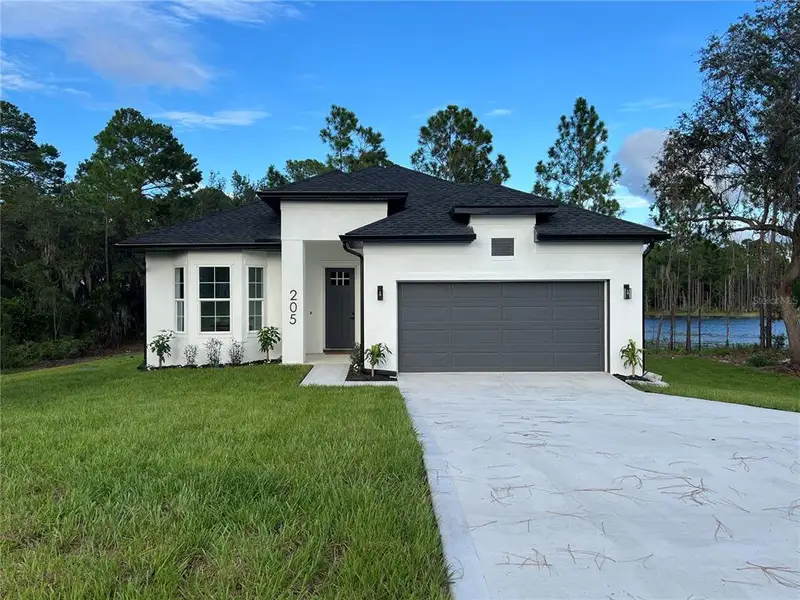 Front exterior of a new home in , Deltona, FL, highlighting curb appeal (Image 1). Front exterior of a new home in , Deltona, FL, highlighting curb appeal (Image 1).