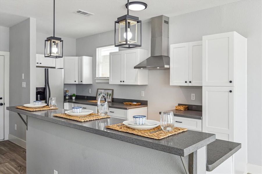 Kitchen features shaker cabinets and stainless steel appliances.