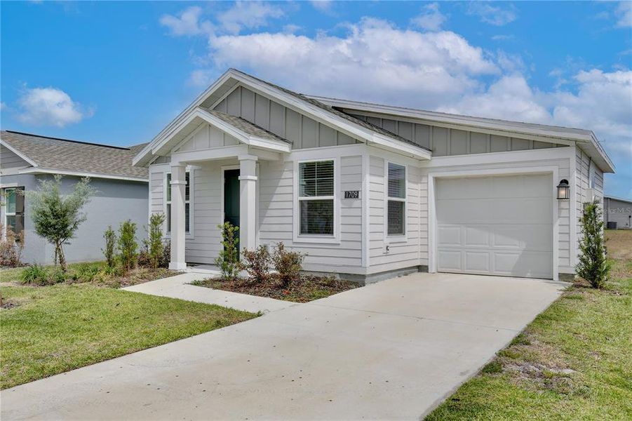 Front exterior of a new home in Peace Creek Reserve, Winter Haven, FL, highlighting curb appeal (Image 24).