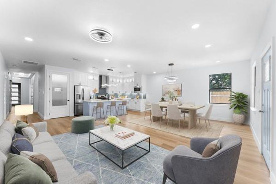 Living area featuring light wood-style floors, recessed lighting, and stairs Living area featuring light wood-style floors, recessed lighting, and stairs