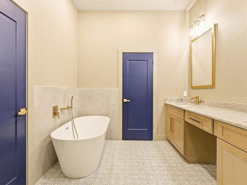 Bathroom featuring a freestanding bath and double vanity