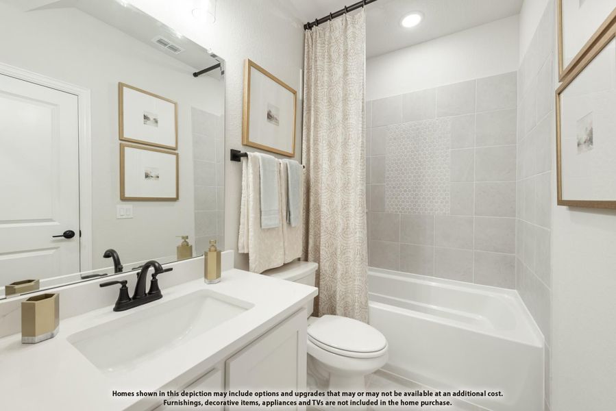 Bathroom with white vanity, tiled tub-shower combo, and patterned curtain Bathroom with white vanity, tiled tub-shower combo, and patterned curtain