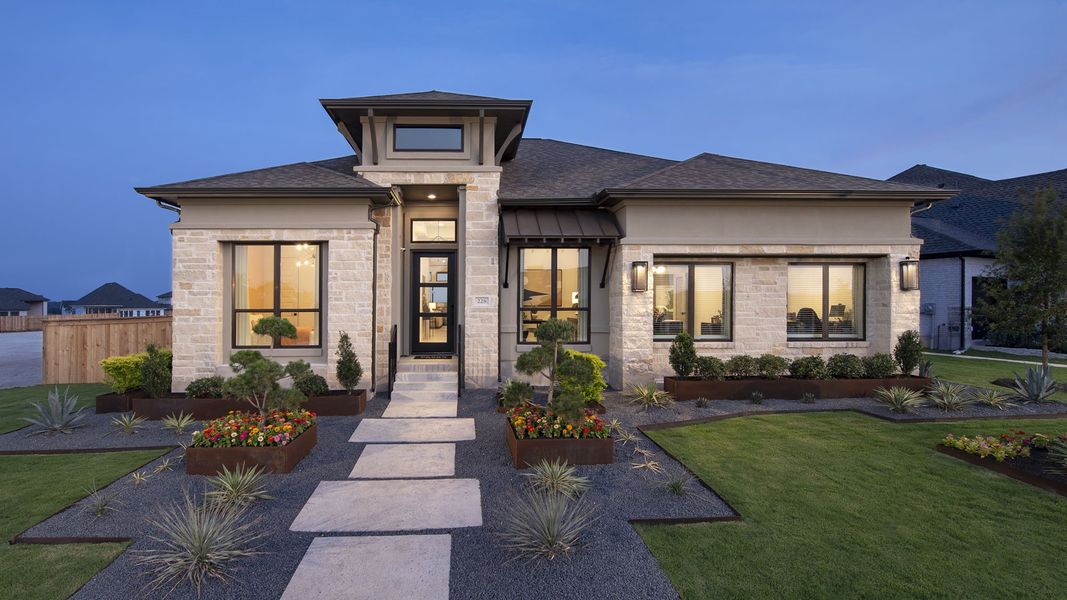 Front exterior of a new home in Trinity Falls, McKinney, TX, highlighting curb appeal (Image 22).
