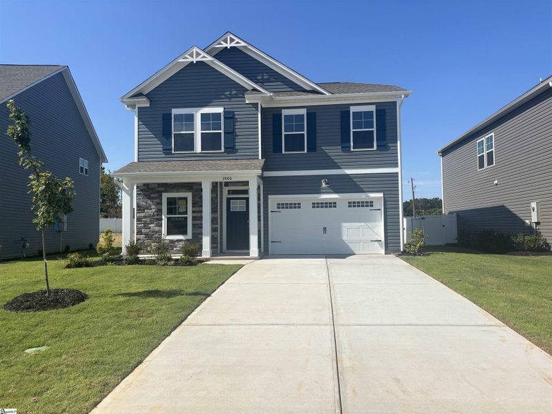 Front exterior of a new home in Halton Oaks, Spartanburg, SC, highlighting curb appeal (Image 1).