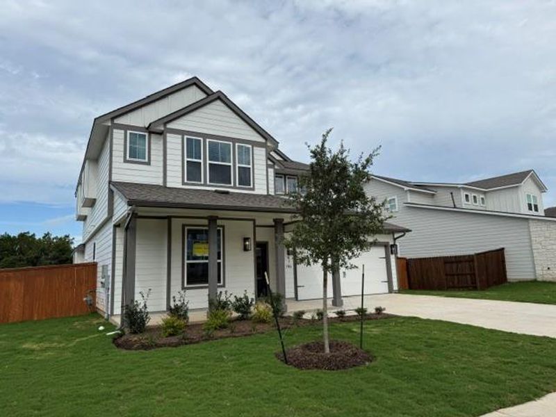 Modern two-story residence with a pristine lawn and attached garage. Modern two-story residence with a pristine lawn and attached garage.