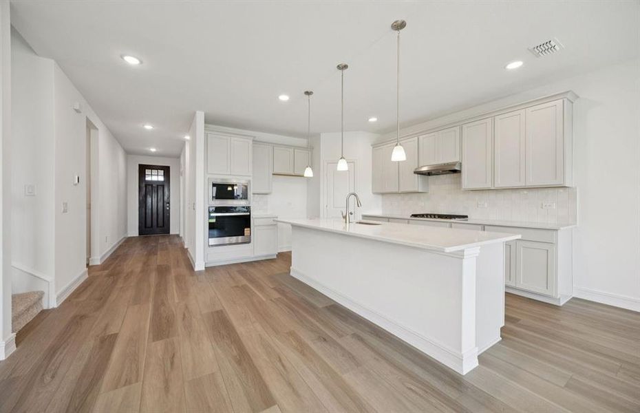 Spacious kitchen with oversized island  *real home pictured