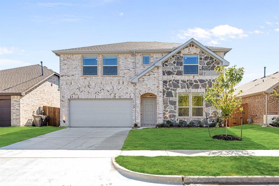 Front exterior of a new home in Rolling Meadows, Lancaster, TX, highlighting curb appeal (Image 21). Front exterior of a new home in Rolling Meadows, Lancaster, TX, highlighting curb appeal (Image 21).