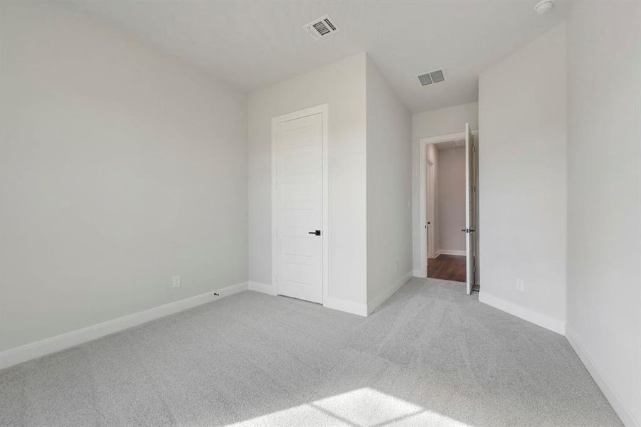 Unfurnished bedroom with carpet and baseboards