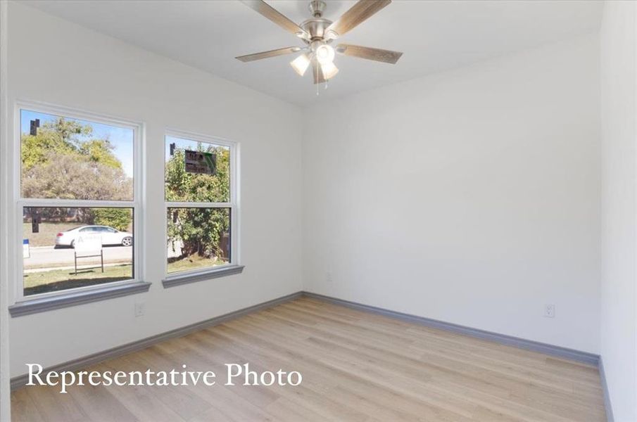 Empty room featuring ceiling fan and light hardwood / wood-style flooring