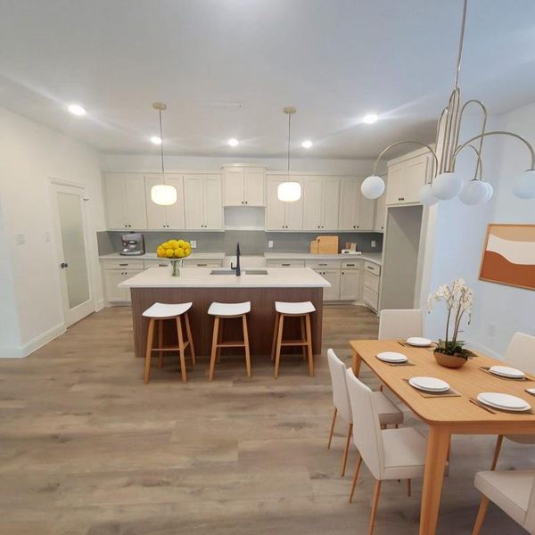 Dining space with sink and light wood-style flooring. Photo generated with AI furniture not included in the sale.