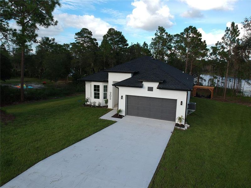 Front exterior of a new home in , Deltona, FL, highlighting curb appeal (Image 33). Front exterior of a new home in , Deltona, FL, highlighting curb appeal (Image 33).