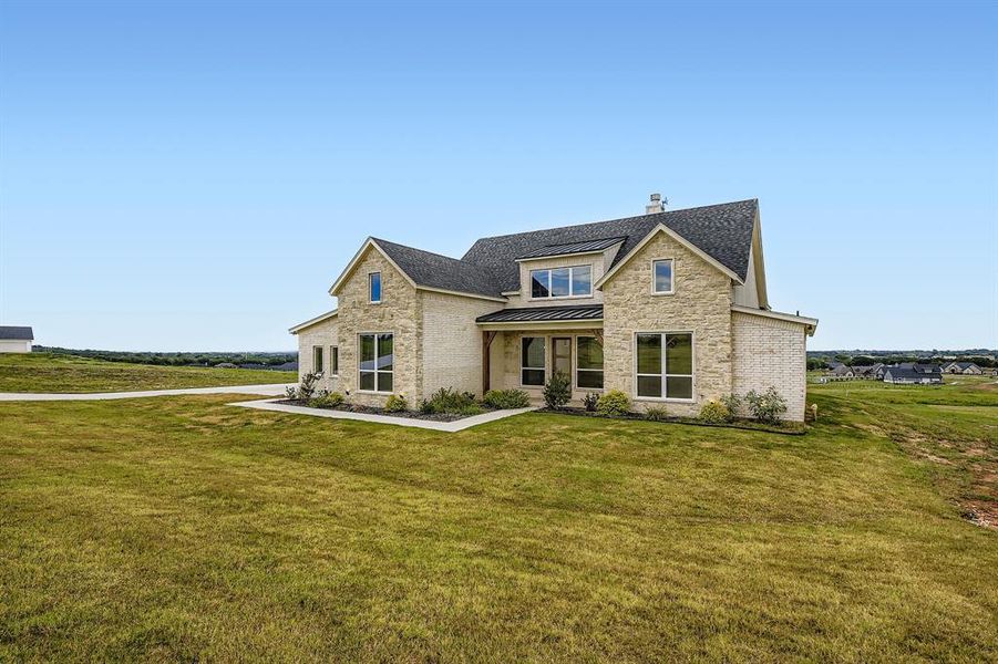 Front exterior of a new home in , Springtown, TX, highlighting curb appeal (Image 2). Front exterior of a new home in , Springtown, TX, highlighting curb appeal (Image 2).
