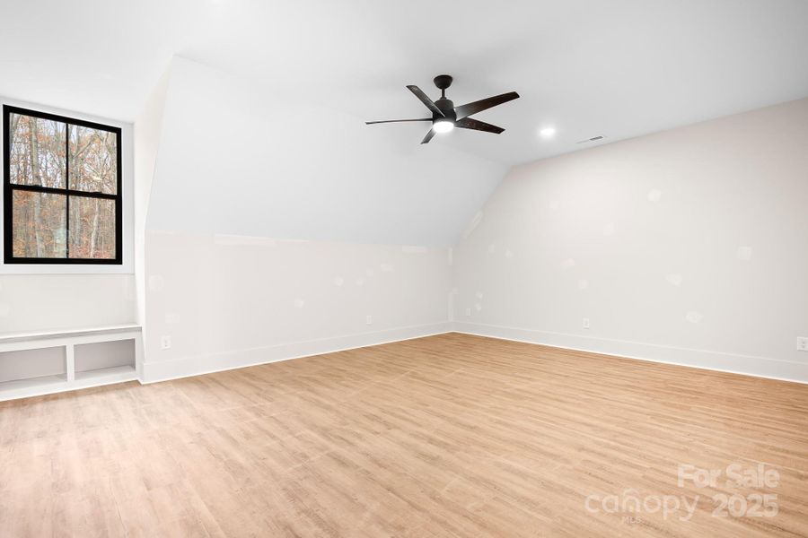 These oversized bedrooms offer enough space for a full bedroom suite plus a cozy lounge area. Built in shelving and a charming bench seat add character and practicle storage. Connected by a stylish jack-and-jill bathroom, the space features a gorgeous dual sink vanity and separate shower room. This space would function as a second primary suite, too!