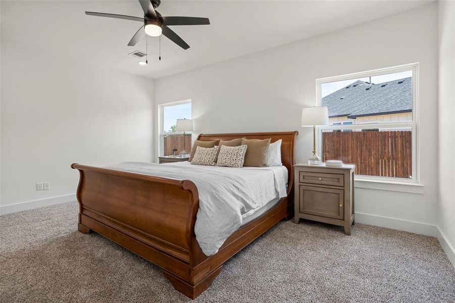 Bedroom with light carpet and ceiling fan