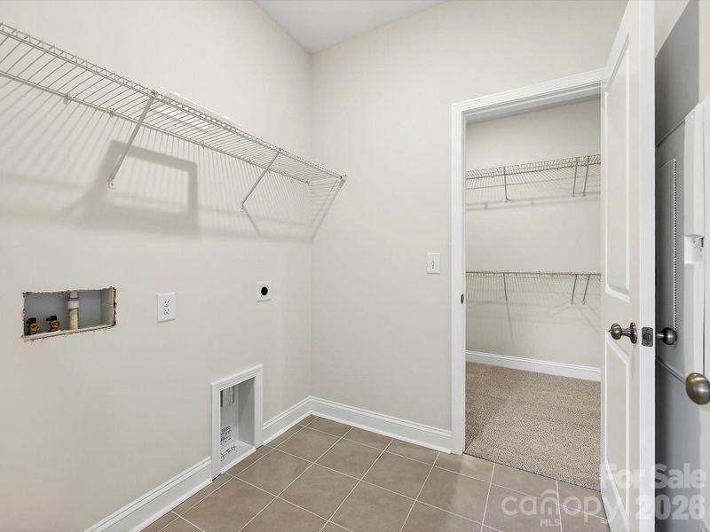 Owner's closet with direct access to the laundry room