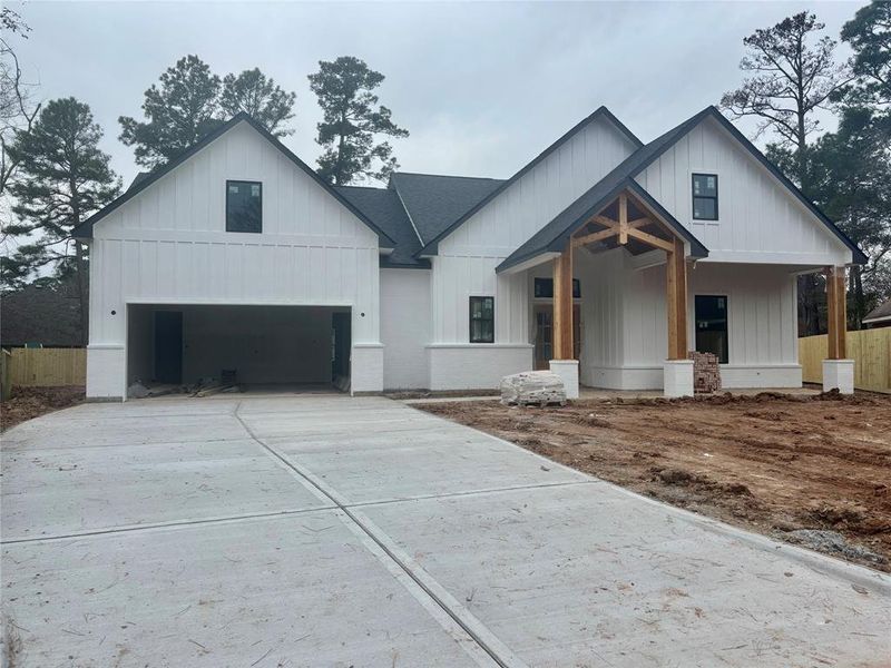 Front exterior photo with oversized driveway, 2 car garage + storage closet.