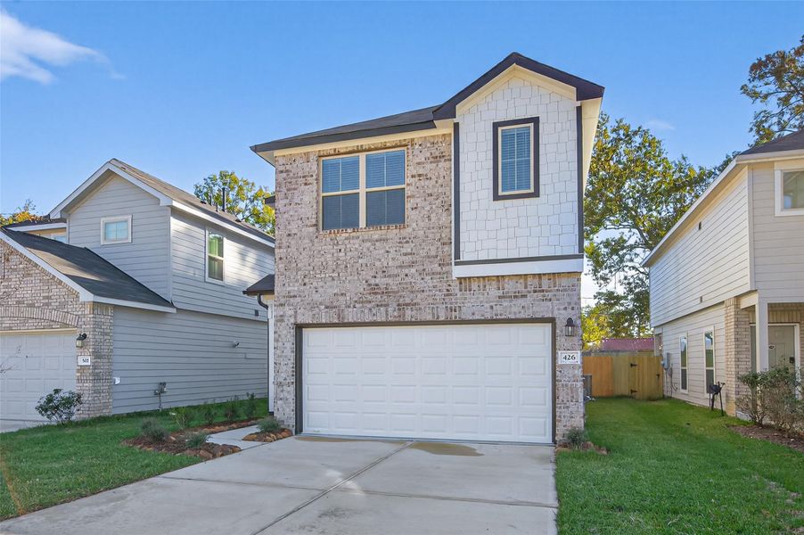Front exterior of a new home in Woodland Lakes, Huffman, TX, highlighting curb appeal (Image 27). Front exterior of a new home in Woodland Lakes, Huffman, TX, highlighting curb appeal (Image 27).