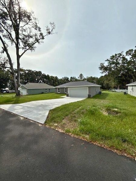 Front exterior of a new home in , Dunnellon, FL, highlighting curb appeal (Image 15).