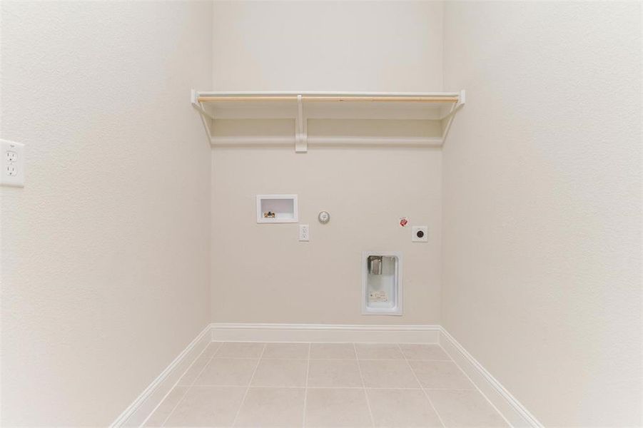 Laundry room with hookup for a gas dryer, tile patterned floors, hookup for an electric dryer, and hookup for a washing machine