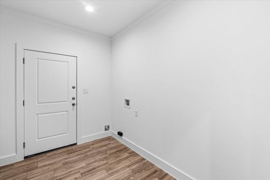 Laundry room with door that leads to the side. Laundry room with door that leads to the side.