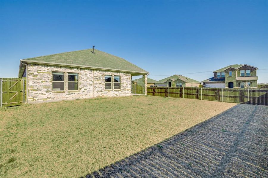 Fenced backyard with a gate