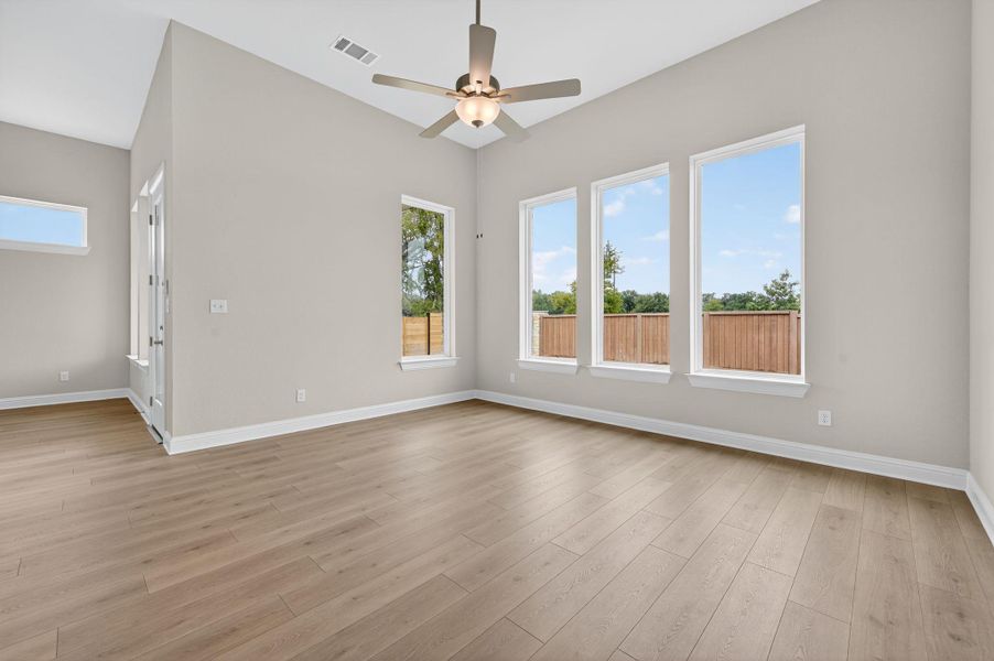 Unfurnished living room featuring a ceiling fan and light wood finished floors