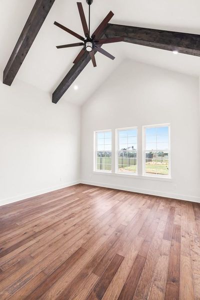 Primary bedroom with vaulted ceiling, engineered wood flooring, beam ceiling, a ceiling fan, and recessed lighting Primary bedroom with vaulted ceiling, engineered wood flooring, beam ceiling, a ceiling fan, and recessed lighting