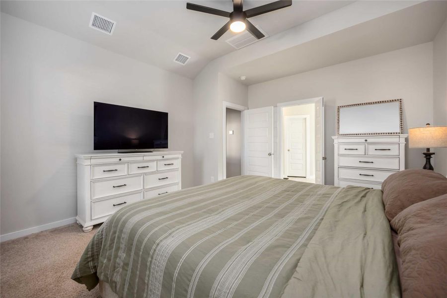 Alternate view of the primary suite showcasing the spacious layout and generous wall space for furniture placement. Alternate view of the primary suite showcasing the spacious layout and generous wall space for furniture placement.