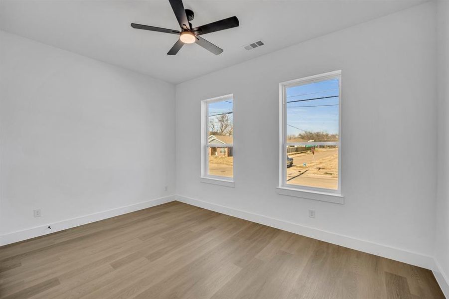 Spare room with ceiling fan and light wood-type flooring