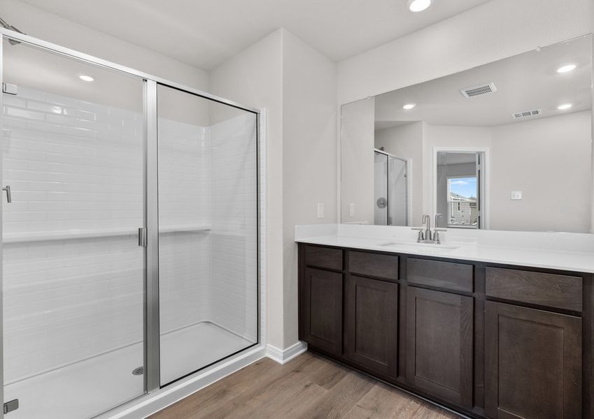 The master bathroom has a sprawling vanity and glass, walk-in shower. The master bathroom has a sprawling vanity and glass, walk-in shower.